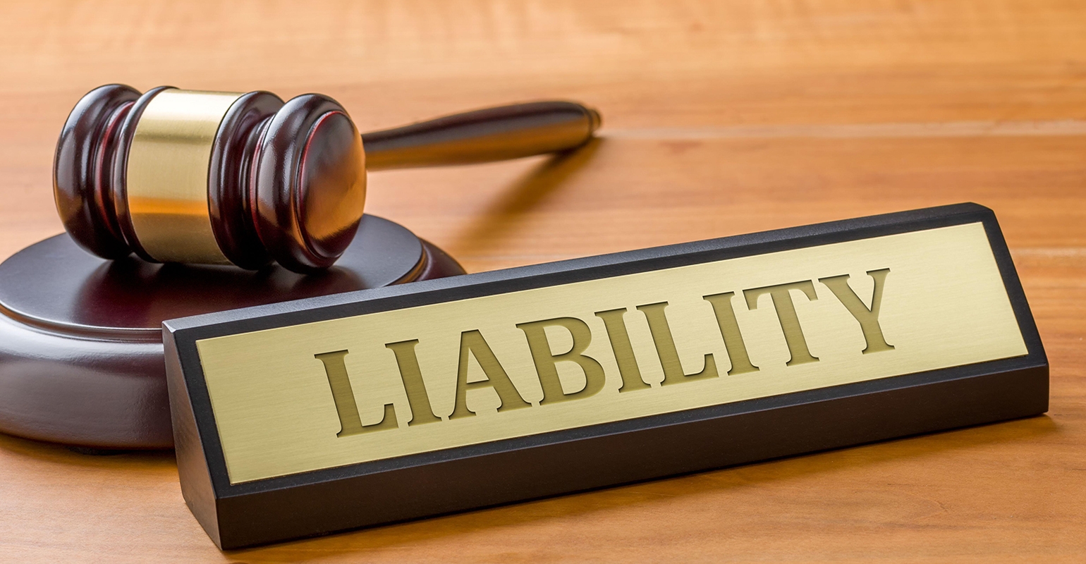 Liability desk sign next to a gavel