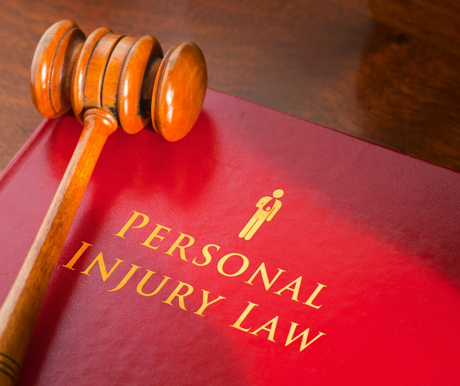 Red personal injury law book with gavel on top of it