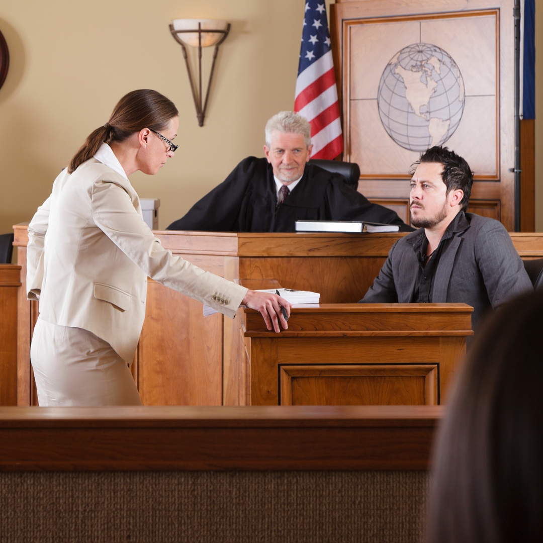 Lawyer questioning witness in court with a judge