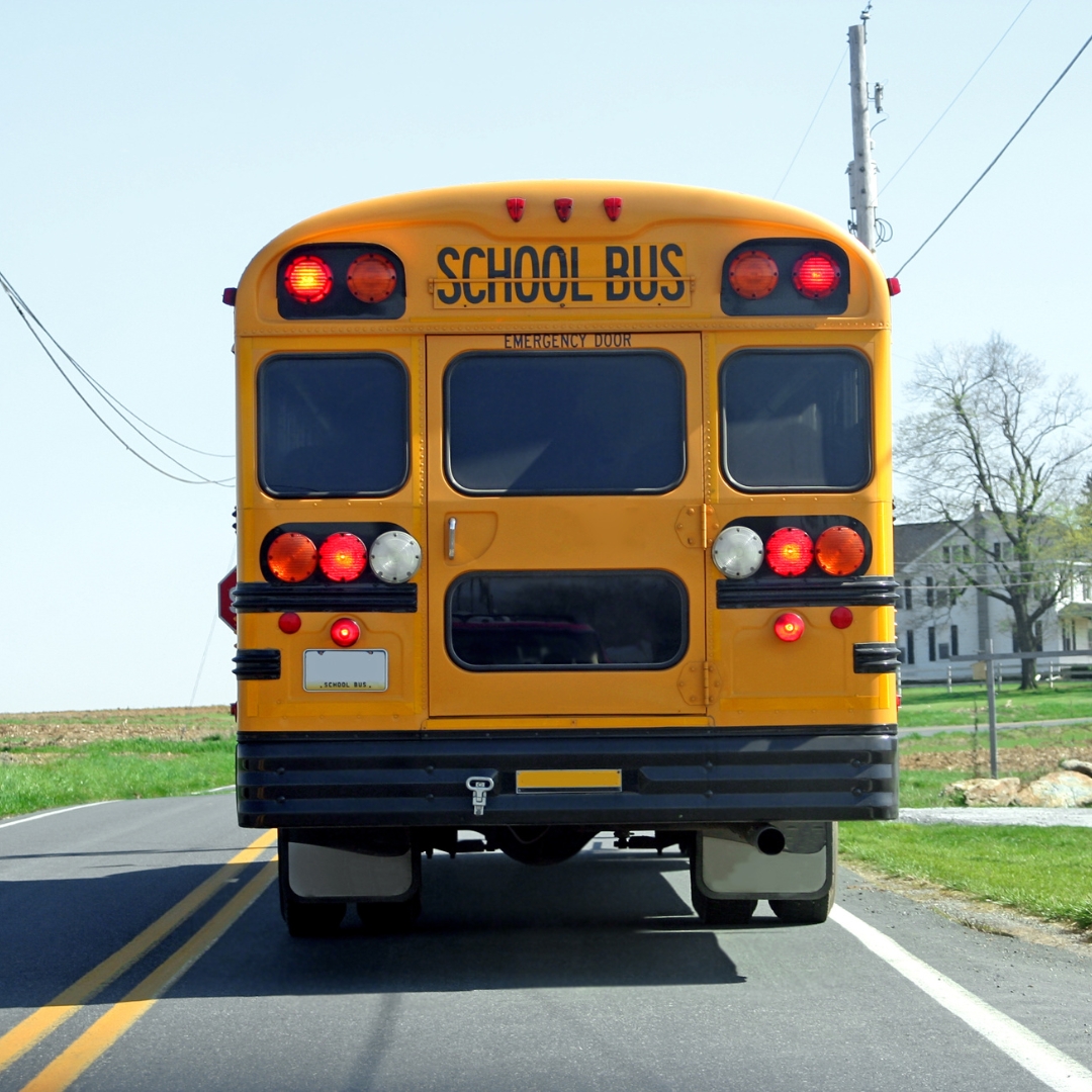 Rear end of a school bus on a rural road