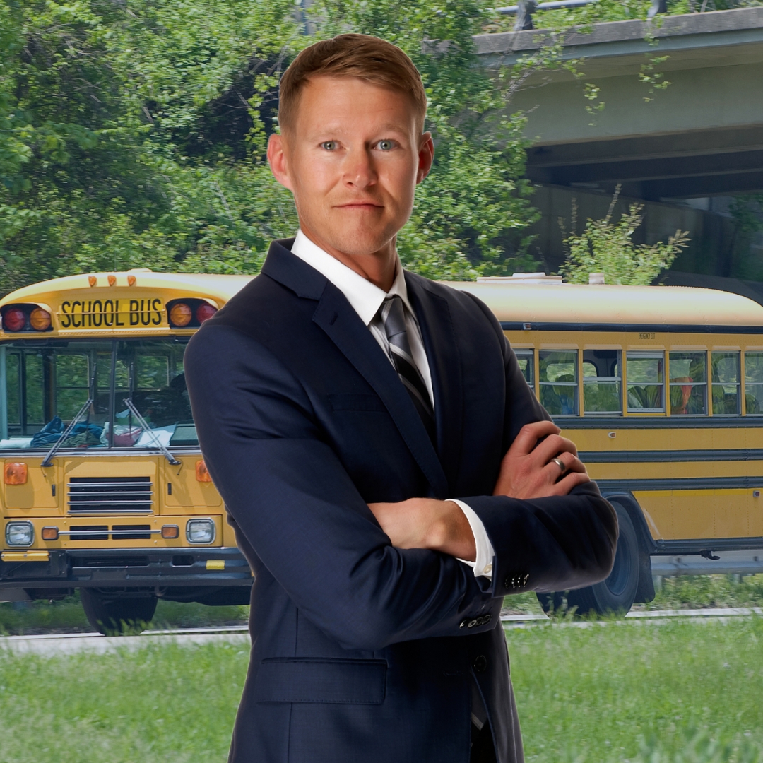 Attorney Mike Chaloupka in front of a school bus