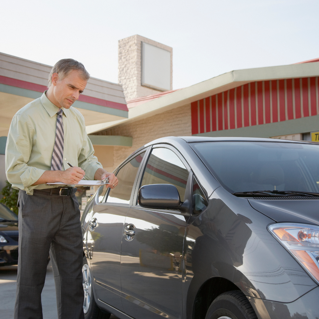 Insurance adjuster inspecting a car