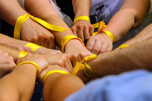 Hands with Yellow Ribbons