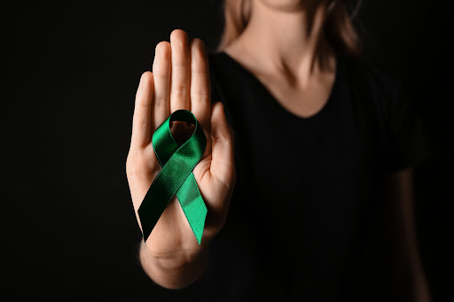 Woman Holding Liver Cancer Ribbon